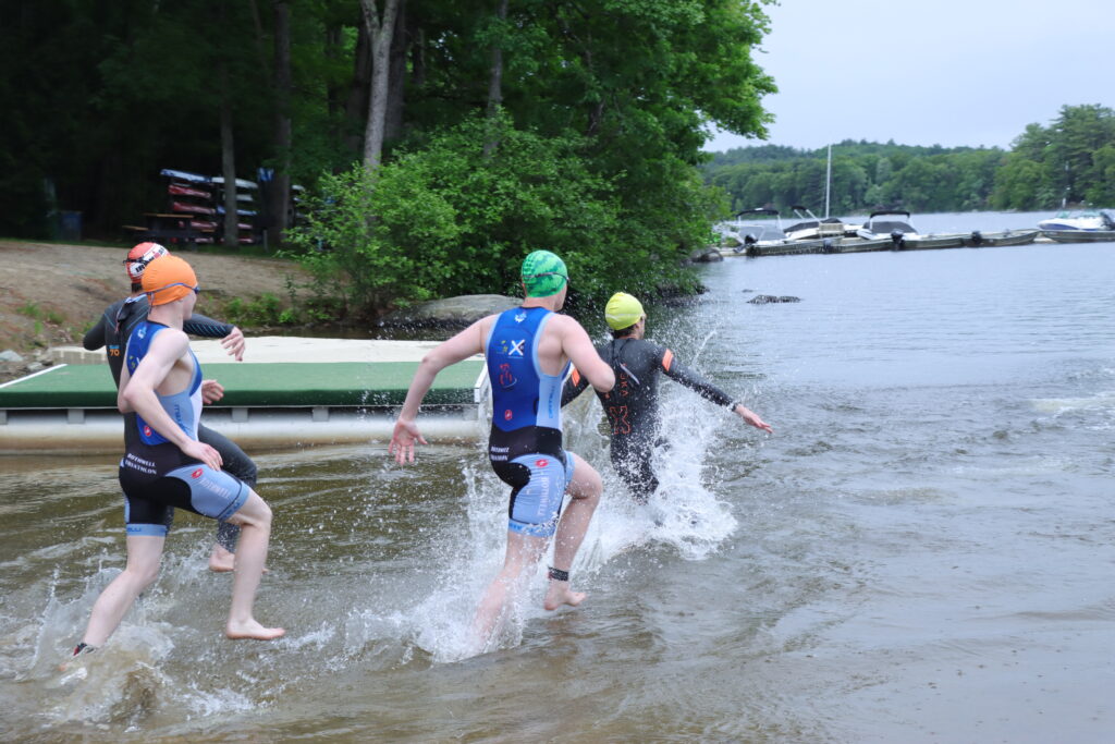 contestants running into water