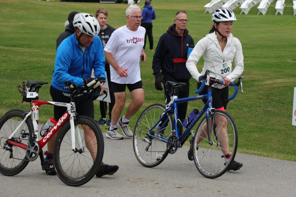 bikers walking their bikes to the race